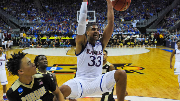 Mar 23, 2017; Kansas City, MO, USA; Kansas Jayhawks forward Landen Lucas (33) dunks as Purdue Boilermakers guard Carsen Edwards (3) looks on during the game in the semifinals of the midwest Regional of the 2017 NCAA Tournament at Sprint Center. Kansas defeated Purdue 98-66. Mandatory Credit: Denny Medley-USA TODAY Sports